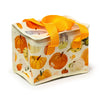 Elevated view of an Autumn Harvest cool bag with a cream background, autumnal pumpkin and gourd pattern, orange webbed handles, and a white zip closure.