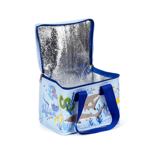 Angled view of an open light blue cool bag with a marine animal pattern, featuring sharks, a stingray, an eel, seahorses, and small fish. It has a silver insulated interior and dark blue fabric handles.