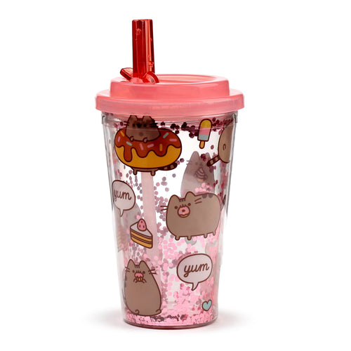 Angled view of a clear double-walled cup with pink lid and straw, featuring pink glitter and Pusheen cat foodie illustrations.