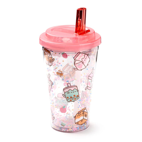 Angled view of a clear double-walled cup featuring cartoon Pusheen characters, milk cartons, bubble tea, strawberries, and apples. It has a pink lid and straw, with colourful floating beads between its walls.