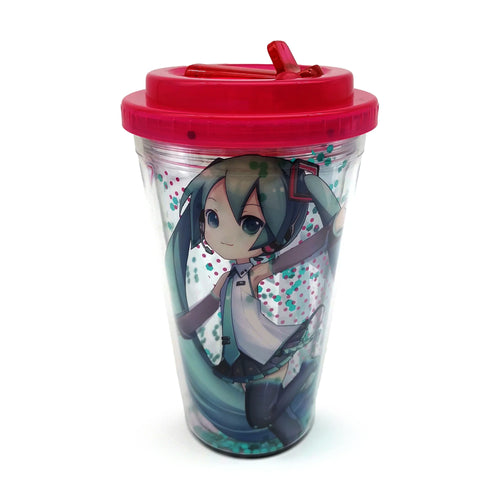 Angled view of a clear double-walled cup with a red lid and integrated flip-up straw spout. The cup features a colourful Hatsune Miku character graphic and floating teal and pink confetti shapes within its walls.