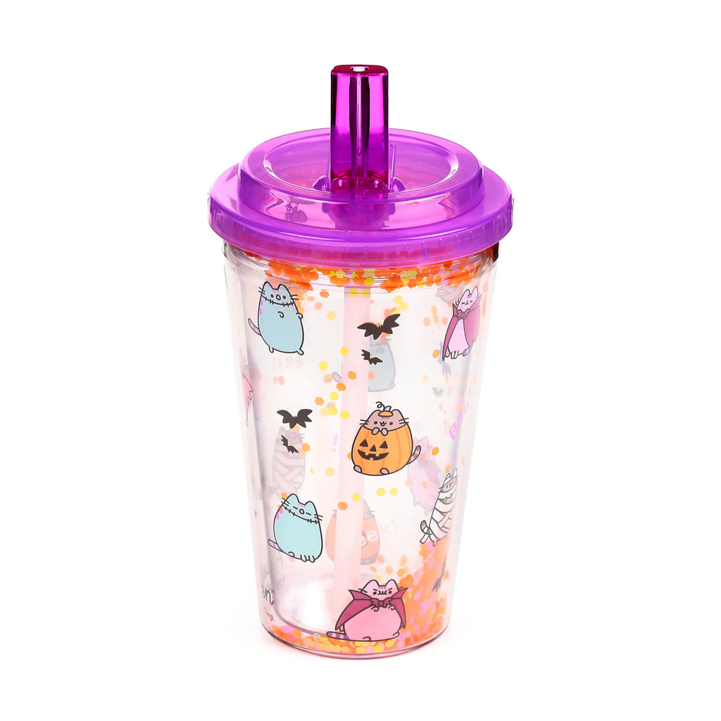 Angled view of a clear double-walled cup with a translucent purple lid and straw, decorated with Halloween-themed cartoon cat characters and orange glitter.