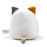 Back view of a white Lola the Cat plush toy, featuring grey and orange ears and a matching grey and orange tail, with a white fabric label attached.