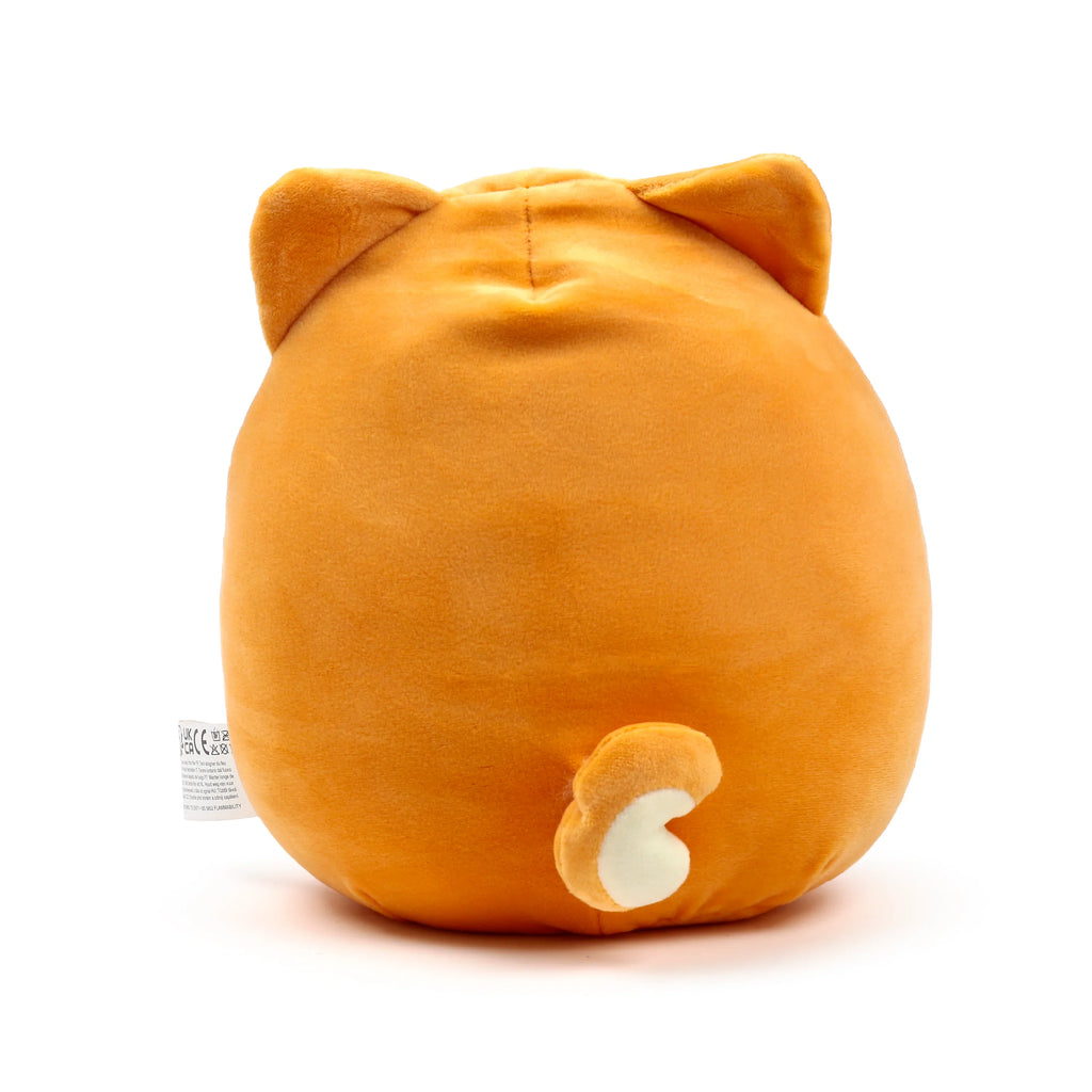 Back view of a soft orange/brown Shiba Inu dog plush toy, featuring pointed ears, a curled white-tipped tail, and a visible care label on the side.