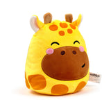 Angled front view of a yellow Squidglys giraffe plush toy, featuring orange spots, brown ossicones, a smiling embroidered face with pink cheeks, and a white product tag.