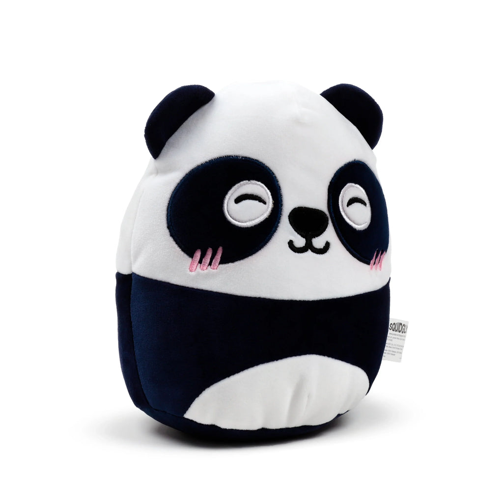 Angled view of a black and white Susu the panda plush toy, featuring embroidered sleepy eyes and pink cheek details.