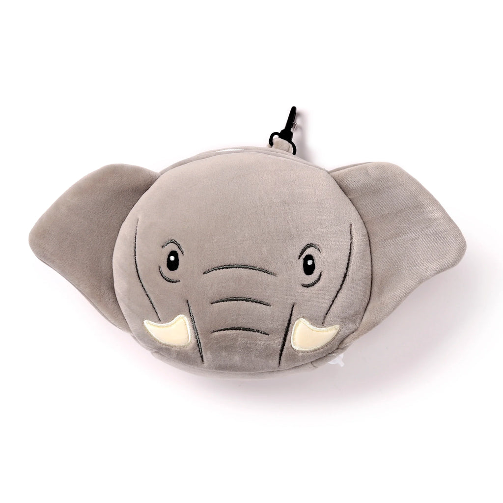Front view of a plush grey elephant travel pillow and eye mask, featuring embroidered eyes, trunk, and white tusks, with a black clip at the top.
