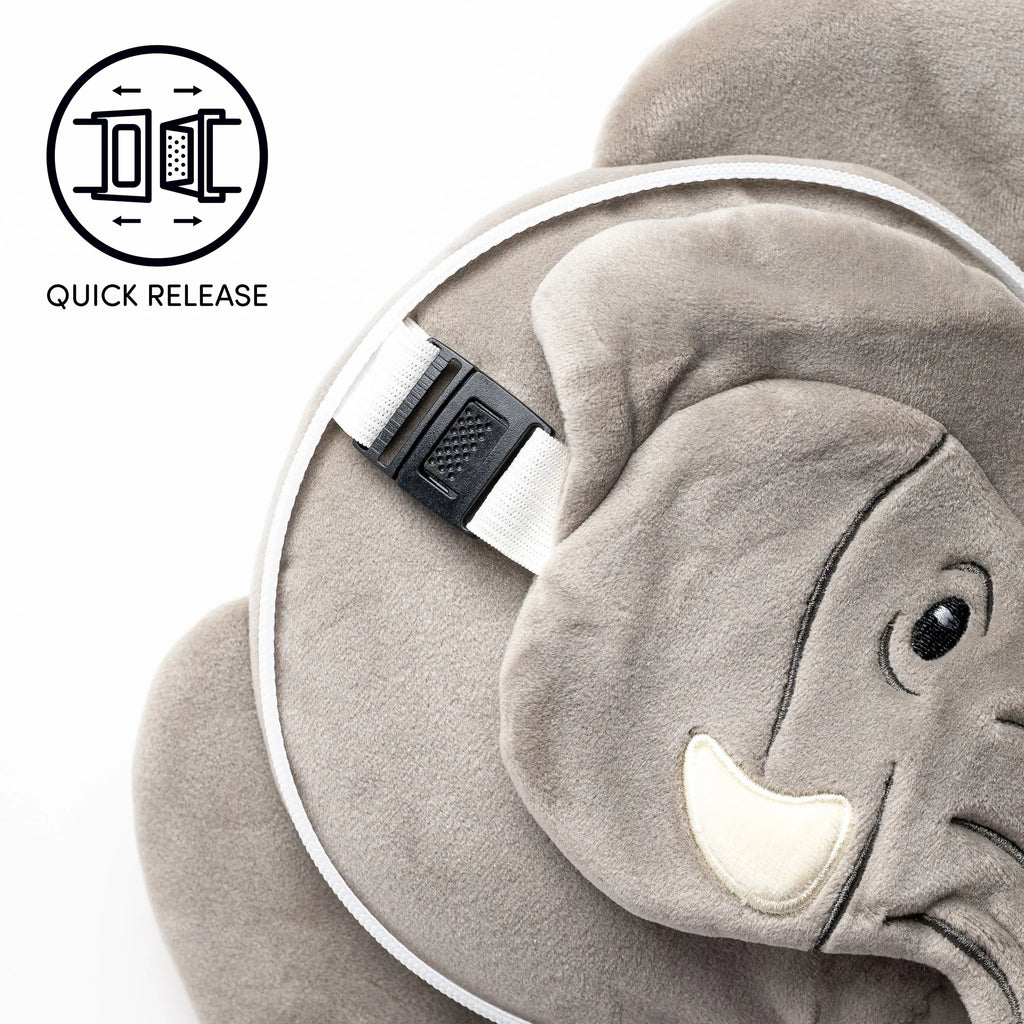 Close-up of a grey elephant travel pillow, highlighting the black quick-release buckle on a white strap, an embroidered eye, and a 'Quick Release' graphic icon.