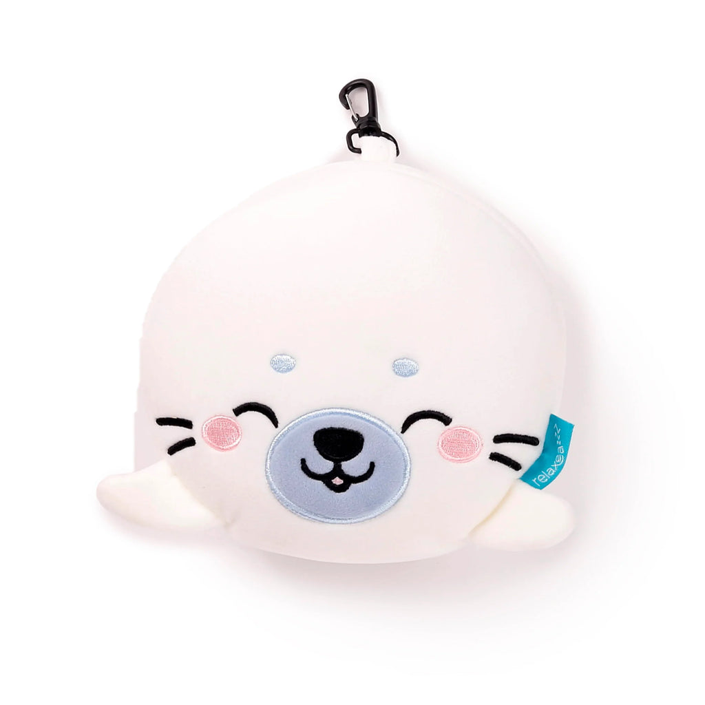 Front view of a white plush seal character travel pillow, featuring embroidered black dot eyes, light blue dots above the eyes, an embroidered light blue snout with a black nose, pink cheeks, black whiskers, and a black carabiner clip.