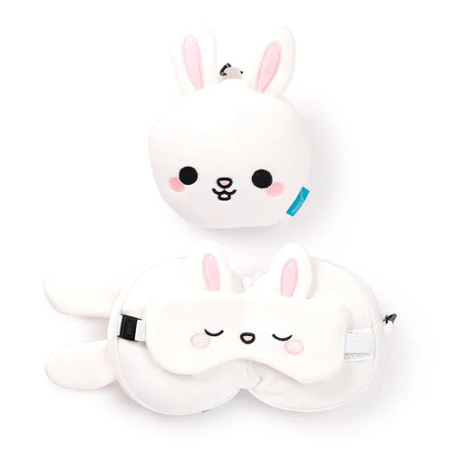 White rabbit travel pillow and eye mask set, overhead view. The set includes a compact plush rabbit head and a U-shaped pillow with a matching sleepy rabbit eye mask, all featuring pink inner ears and embroidered details.