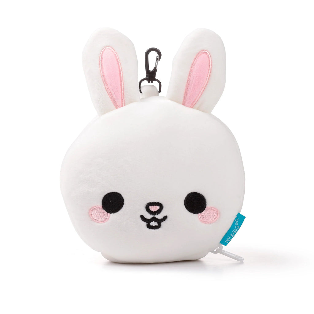 Front view of a white plush rabbit travel pillow, featuring pink inner ears, black embroidered eyes, nose, and mouth, with pink cheek details and a black carabiner clip.