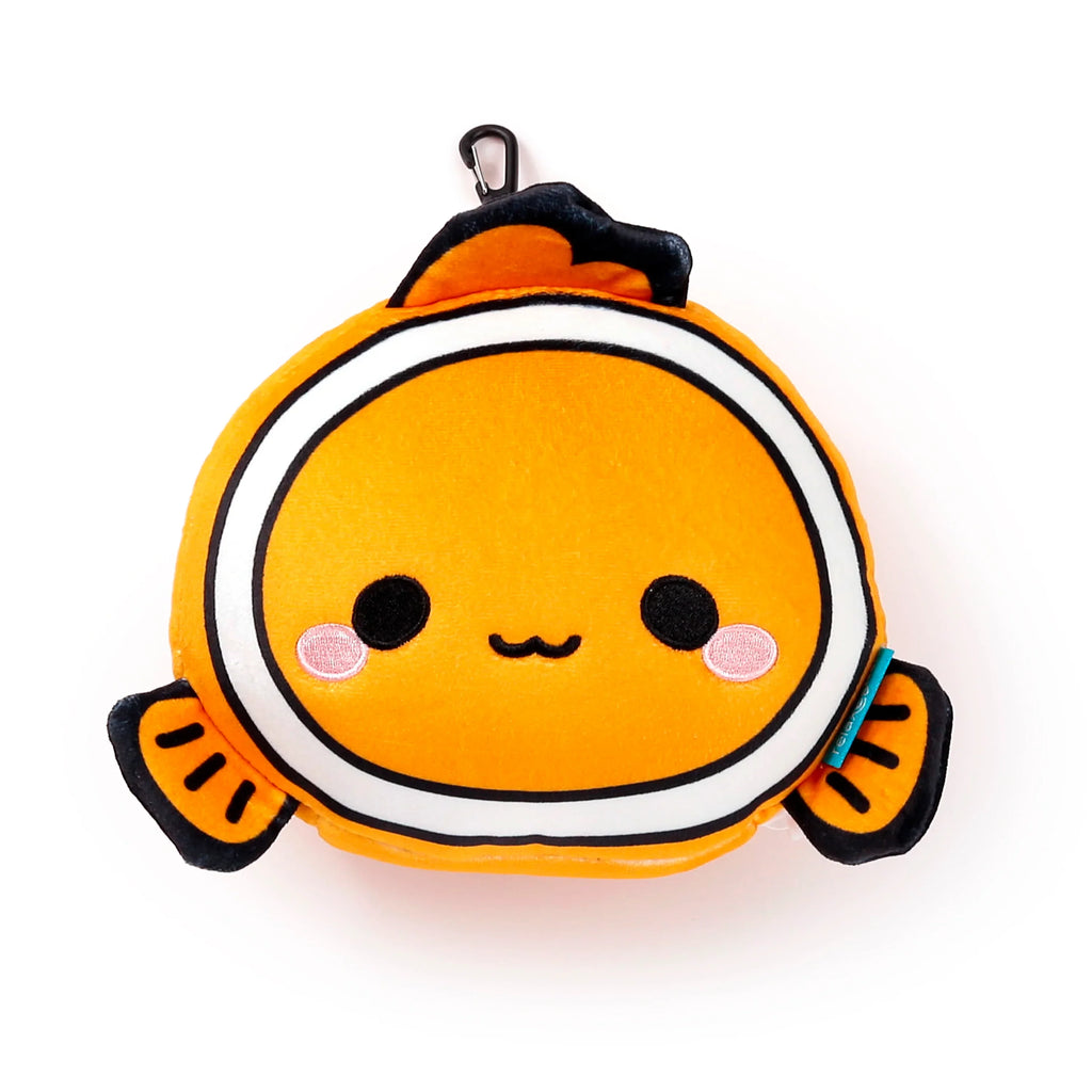 Front view of an orange, white, and black plush clown fish travel pillow, with embroidered eyes, mouth, and pink cheeks, and a black carabiner clip at the top.