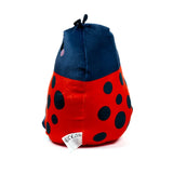 Red and black spotted ladybug plush toy, angled view showing dark blue head with antennae and care label.