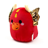 Angled view of a red Squidglys dragon plush toy with an orange snout, black eyes, pink cheeks, yellow head spots, cream horns, and shiny gold crinkled wings.