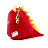 Angled view of a red plush dragon toy, displaying golden crinkly wings, yellow ridged back spines, and cream horns, with a white product label on its side.