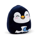 Angled front view of a dark blue penguin plush toy with a white belly and face, featuring smiling eyes, an orange beak, and pink cheek marks. The penguin is holding a small blue fish.