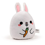 Front view of a white Squidglys Adoramals Frances the Bunny plush toy, with pink inner ears, black eyes, pink cheeks, and holding an orange carrot.