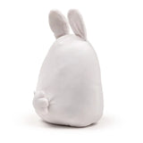 Rear view of a white bunny plush toy with upright ears and a small fluffy tail.