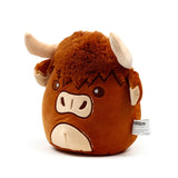Angled front view of a brown Highland Coo cow plush toy with shaggy fur, beige horns, and embroidered facial features.