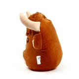 Angled view of a brown Highland coo plush toy, featuring shaggy fur, cream horns, and an eye, against a white background.