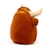 A brown plush Highland Coo Cow toy, shown from an angled perspective, featuring shaggy brown head fur and light-coloured horns.