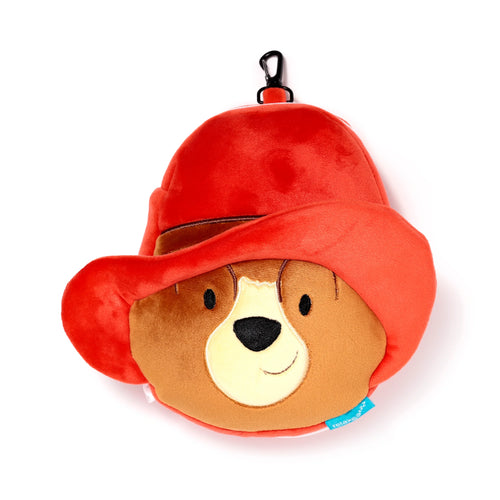 Front view of a plush Paddington Bear travel pillow and eye mask, with a red hat, brown embroidered face, black carabiner clip, and a blue 'Relaxeazzz' label.