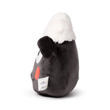 Angled view of a Shaun the Sheep plush toy, showing its dark grey body, fluffy white wool, black ear, and a red cheek.