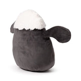 Angled view of a Shaun the Sheep plush toy with a dark grey body, white fluffy head, and dark grey ears, featuring a small red heart detail on its side.