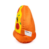 Angled view of a plush pizza slice toy, featuring yellow 'cheese' with red 'pepperoni' and green sprinkles, an orange crust, and cartoon eyes and a mouth. A white care label is visible on the toy's orange side.