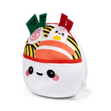Front view of a cute plush ramen bowl with an embroidered face. Features a white base, red rim, yellow noodles, green seaweed, swirled fish cake, and a kawaii egg.
