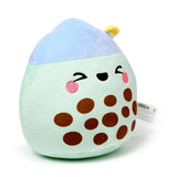 Angled front view of a plush toy depicting Matcha the Bubble Tea, with a light green body, brown 'tapioca' details, a light blue top, and an embroidered winking face with pink cheeks.