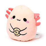 Angled view of a light pink Maddie the Axolotl Squidglys plush toy, featuring embroidered black eyes, pink cheek blushes, and coral-pink feathery gills. It is depicted holding a yellow spiral sweet.