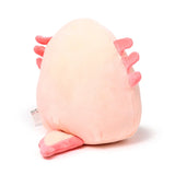 Angled view of a soft, peachy-pink axolotl plush toy, featuring bright pink frills and a flat tail.