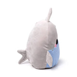 Angled view of a light grey and light blue plush shark toy, showing its embroidered black eye, pink cheek, dorsal fin, and tail fin.