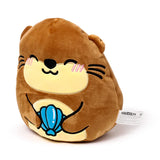 Angled front view of a brown plush otter toy featuring a smiling face, pink cheeks, black whiskers, and holding a blue shell, on a white background.