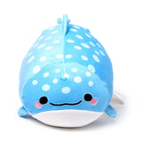 Front view of a light blue plush whale shark toy with white polka dots, black embroidered eyes, a smiling mouth, and pink cheeks.