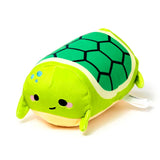 Front view of a green plush turtle toy with a dark green hexagonal shell, black oval eyes, pink cheeks, and light blue spots.