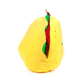 Yellow plush taco toy, showing its colourful red, green, and brown felt fillings and an embroidered face on its side.