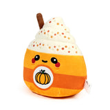 Angled front view of an orange and lighter orange plush toy, shaped like a spiced latte cup. It displays a happy embroidered face, a pumpkin emblem, cream-coloured whipped cream with colourful sprinkles, and a brown cinnamon stick.