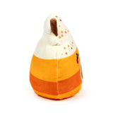 Angled view of a Hazel the Spiced Latte plush toy with a cream-coloured top, colourful embroidered sprinkles, an orange and dark orange striped body, and a brown stick.