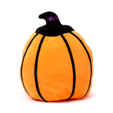 Orange plush pumpkin toy with black ribbed detailing, featuring a black pointed stem and a purple ribbon band.