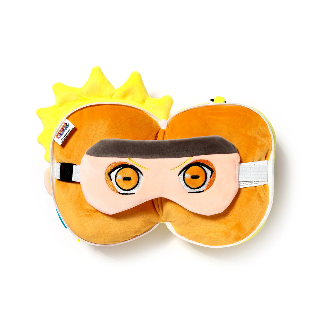 Overhead view of a compact Naruto travel pillow, zipped into a plush, round form with yellow spiky details, and a matching eye mask featuring distinct orange and black Naruto eyes resting on top. The set is displayed against a white background.