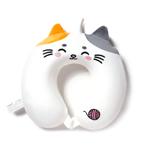 Front view of a plush white U-shaped memory foam travel pillow designed as a cat. It features embroidered closed eyes, pink cheeks, and whiskers, with one orange ear and one grey ear. A pink ball of yarn is embroidered on its lower right side.
