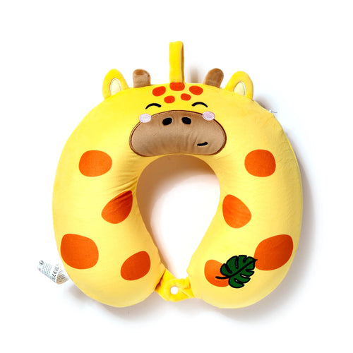 Overhead front view of a plush yellow U-shaped travel pillow with orange spots, styled as a giraffe. It features an embroidered face with sleeping eyes, brown ossicones, ears, pink cheeks, and a small green leaf on the right. A white snap closure connects the pillow's ends.