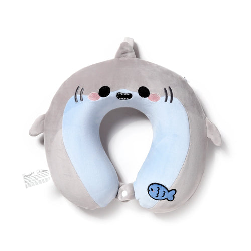 Front view of a grey plush memory foam travel pillow shaped like an adorable shark, featuring embroidered eyes, mouth, pink cheeks, blue inner lining, a small blue fish detail, and a white button closure.