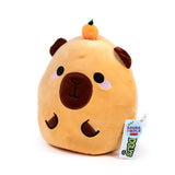 Front view of a Squidglys Duke the Capybara plush toy, a light brown stuffed animal with black eyes, a dark brown nose, pink cheek blush, dark brown ears, and a small orange pumpkin with a green stem on its head. A product tag is visible on its right side.