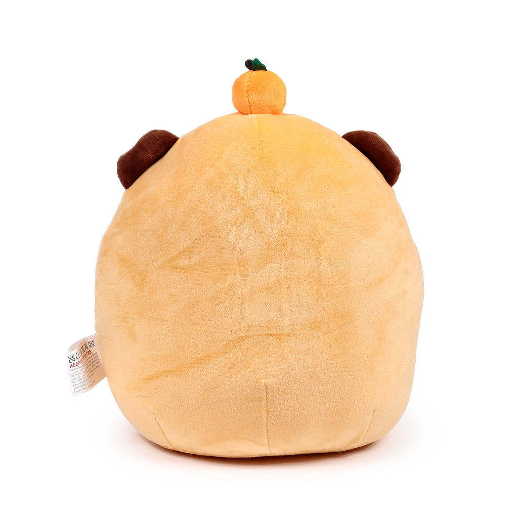 Back view of Duke the Capybara Squidglys plush toy, light brown, featuring a small orange pumpkin on its head, dark brown ears, and a visible care tag.