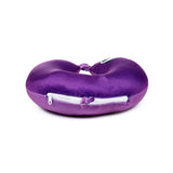 Angled view of a purple plush 2-in-1 travel pillow, with a white zip and a subtle panda eye design on the upper curve.