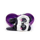 Angled view of a black and white plush panda toy, featuring pink cheeks and dark grey limbs, partially covering a deep purple U-shaped travel pillow with a visible white zip.