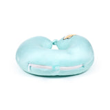 Side view of an aqua blue plush U-shaped travel pillow, featuring a white zip and a partial Shiba Inu face design.